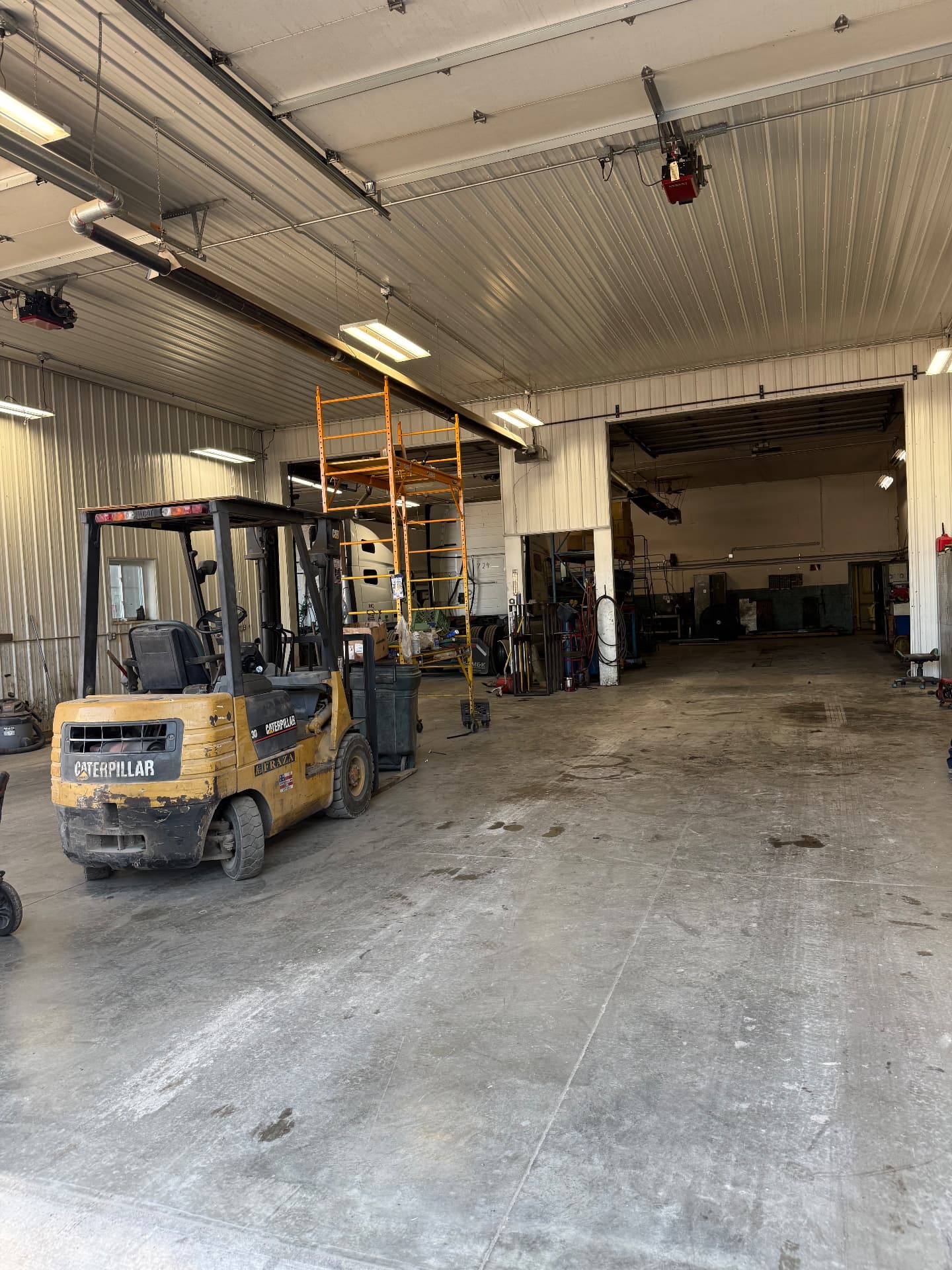 Inside the shop bays with forklift and service equipment