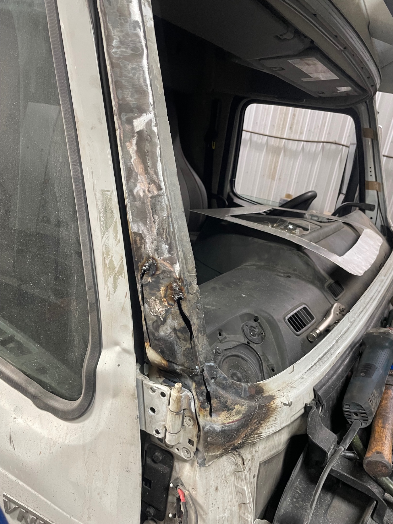 Collision damage to the Volvo cab before repair