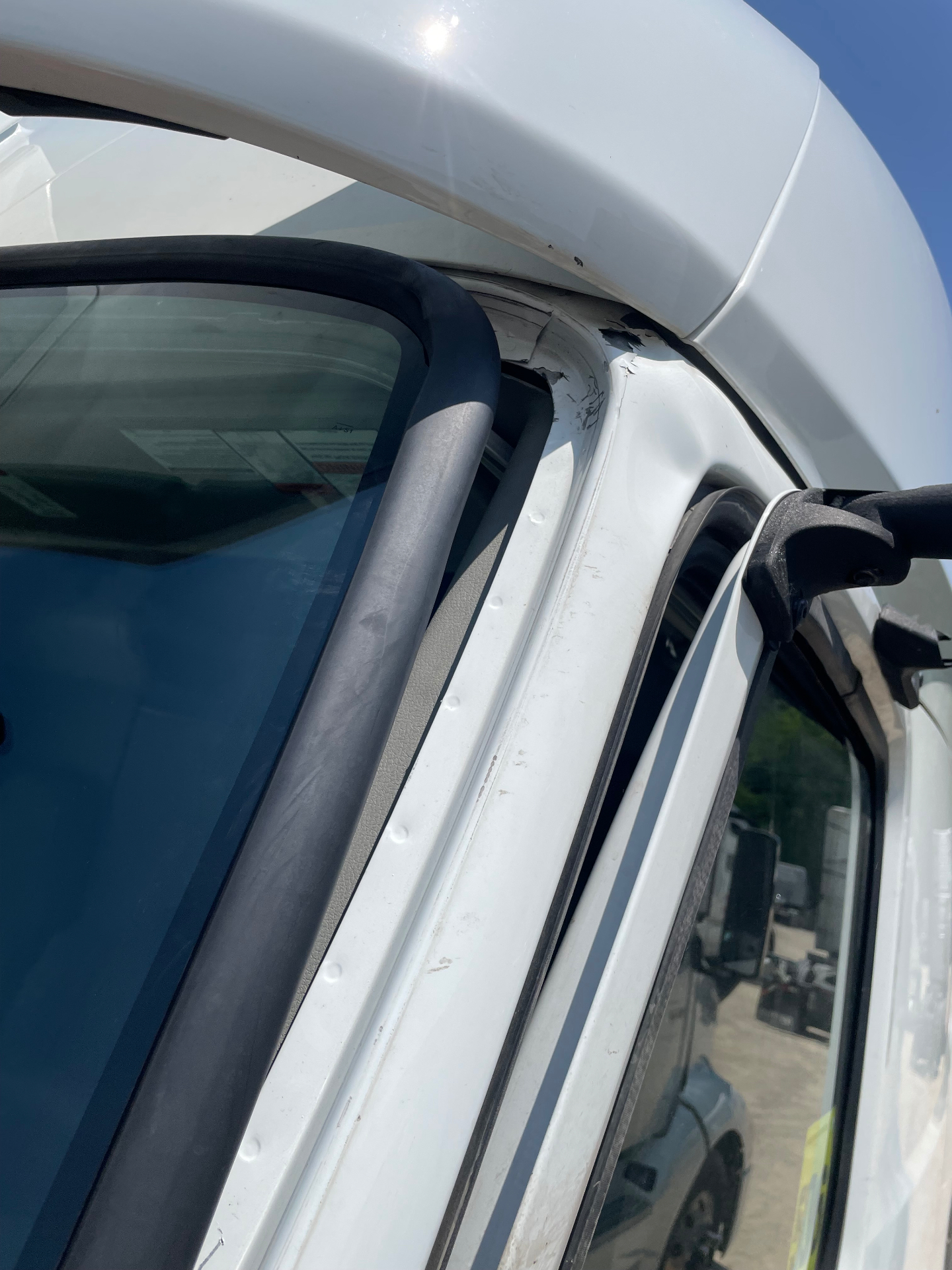 Damaged cab seam and door frame before repair