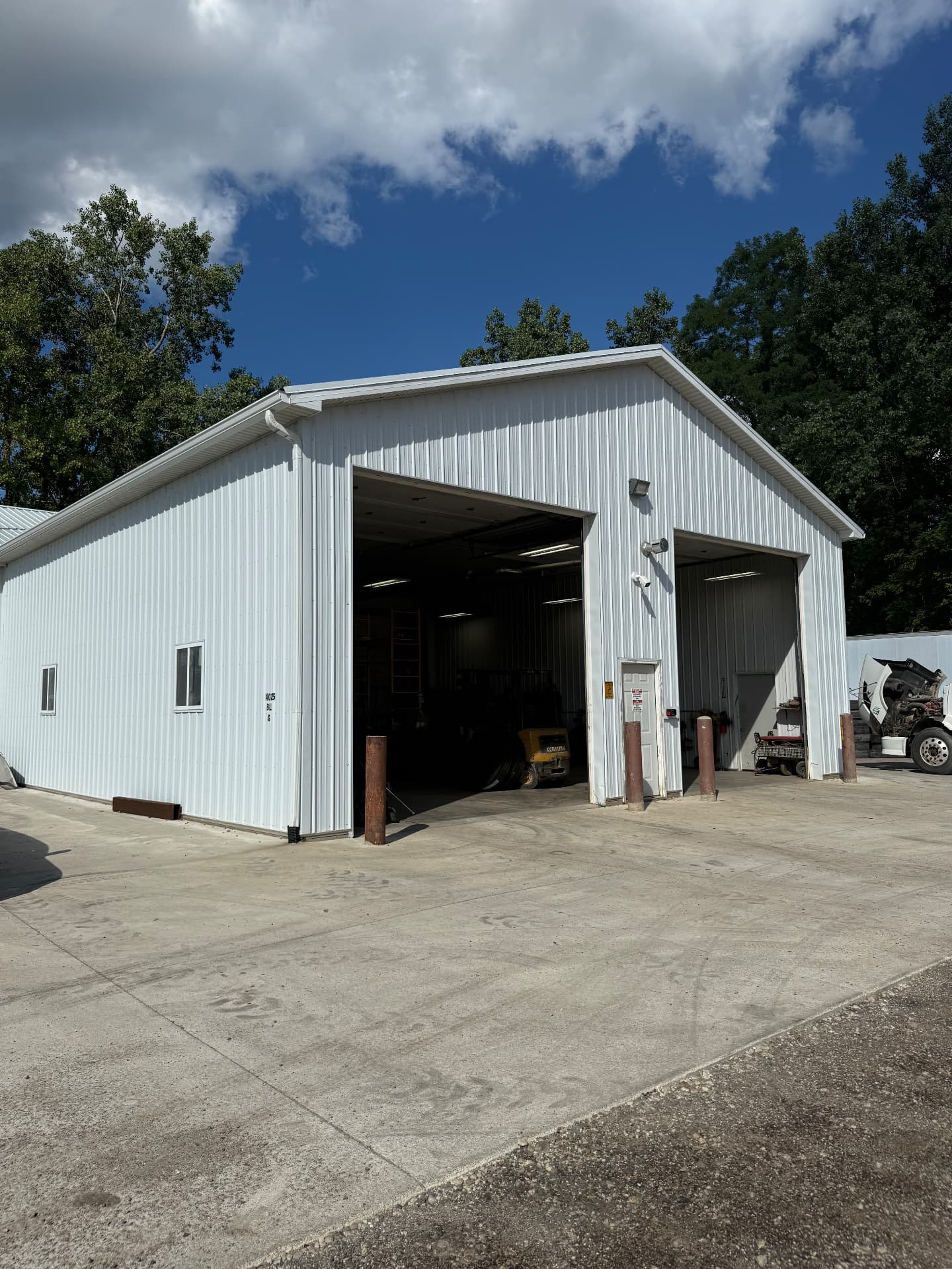 Repair shop bay with equipment and a truck under service